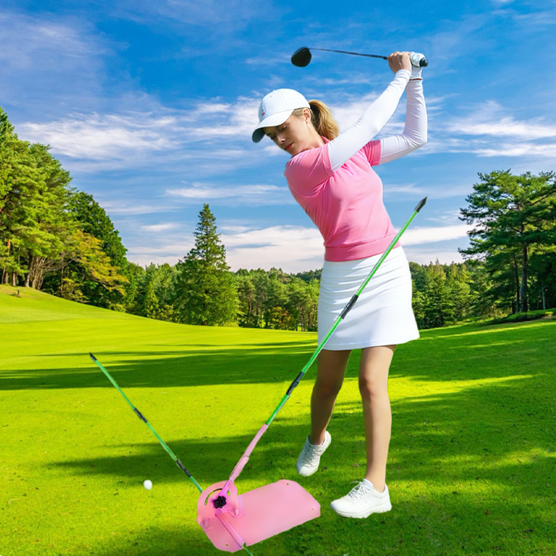 Woman practicing golf swing with Steelink pink swing trainer outdoors